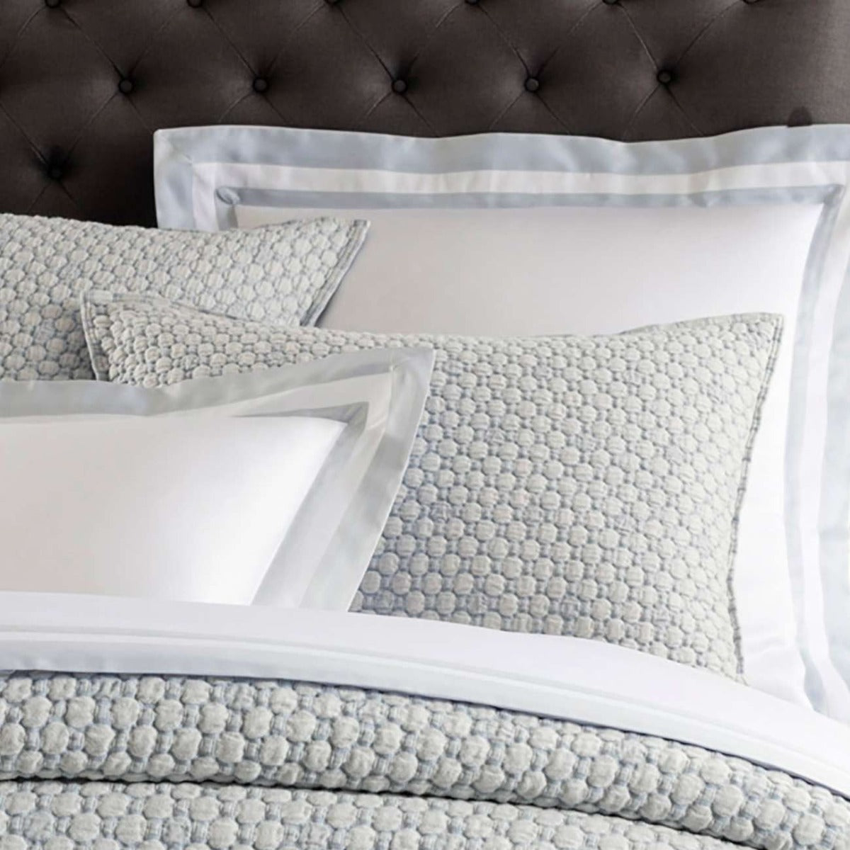 Lodi Blue Matelasse Sham styled with grey bedding. Styled view. 