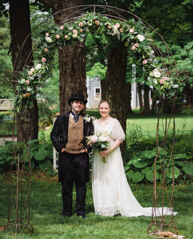 Victorian bride and groom under floral canopy in Kirkside Park Roxbury, New York
