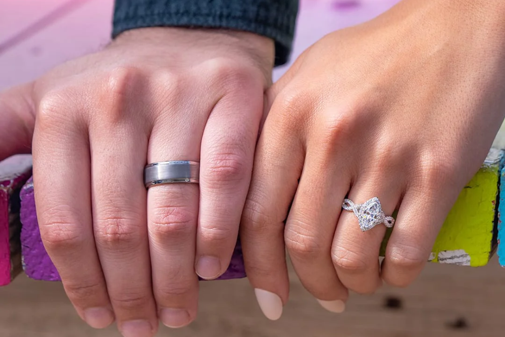 man and woman wearing silver engagement rings