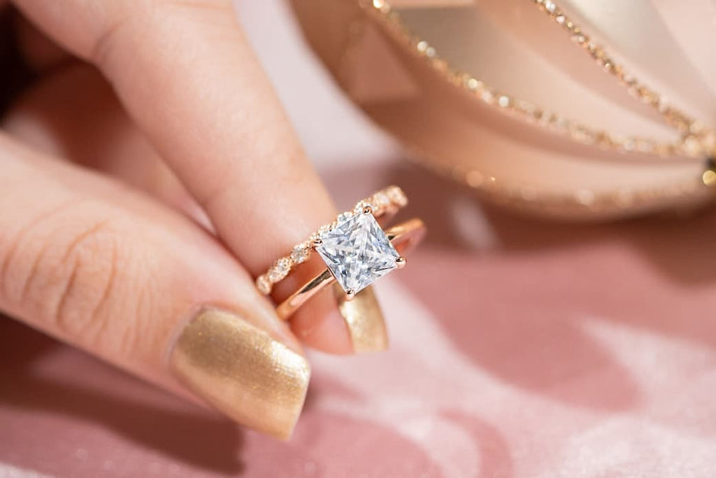 Woman's hand holding The Olivia and The Forever in rose gold