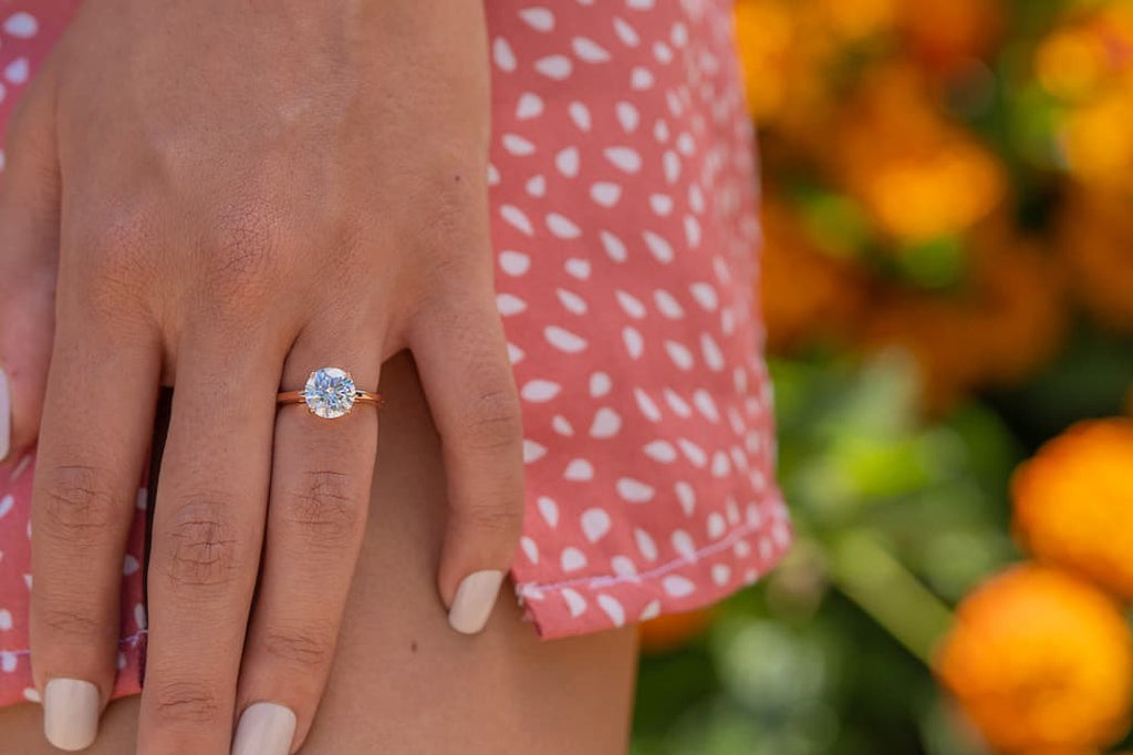 Woman's left hand wearing The One and Only in rose gold on ring finger