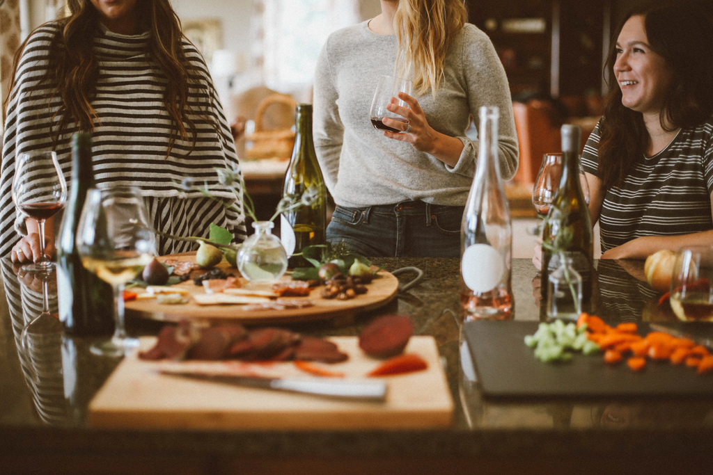 Group of people drinking wine around table