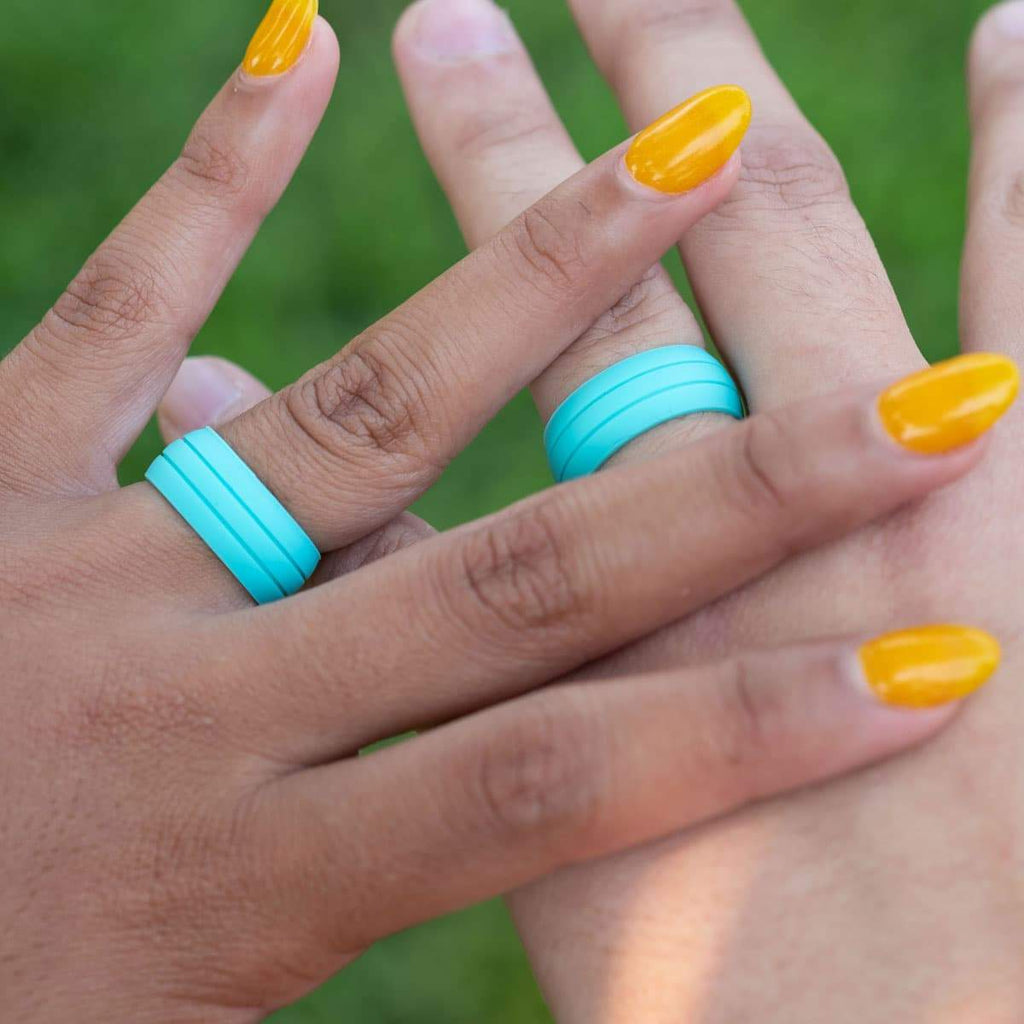 Married couples hands wearing silicone wedding bands