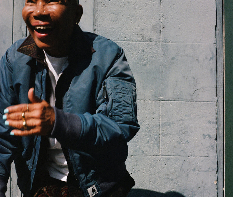 Model wearing Olten Bomber in Blue smiling