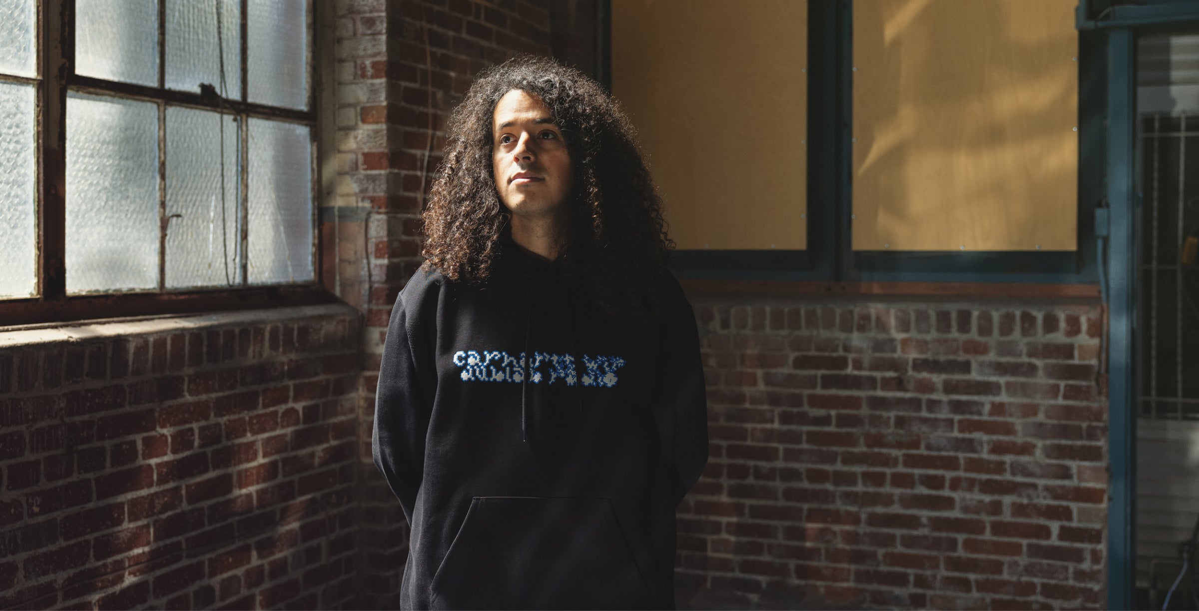 Model wearing dublab hooded sweatshirt in black