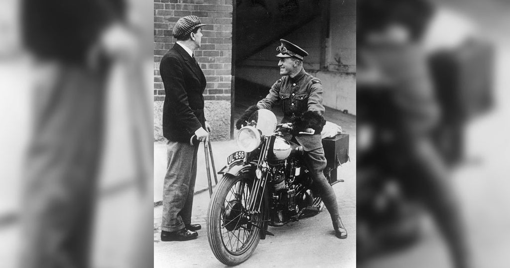 George Brough with crutches after an accident with one of his prototypes, gives Lawrence his brand new SS100 so he can ride it back home for the first time.