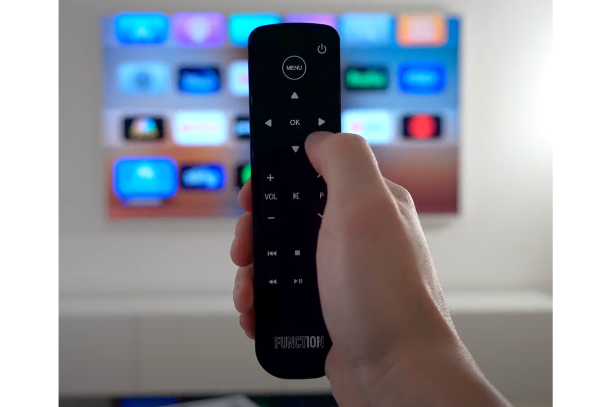 Apple TV replacement remote in hand
