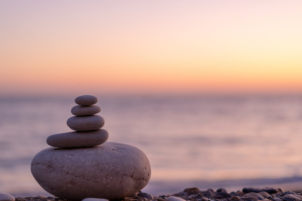 Rocks balanced atop each other on the shore