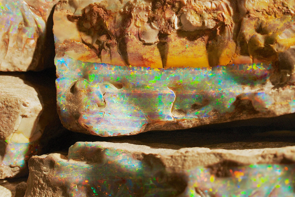 Boulder opal inlaid in the surrounding rock