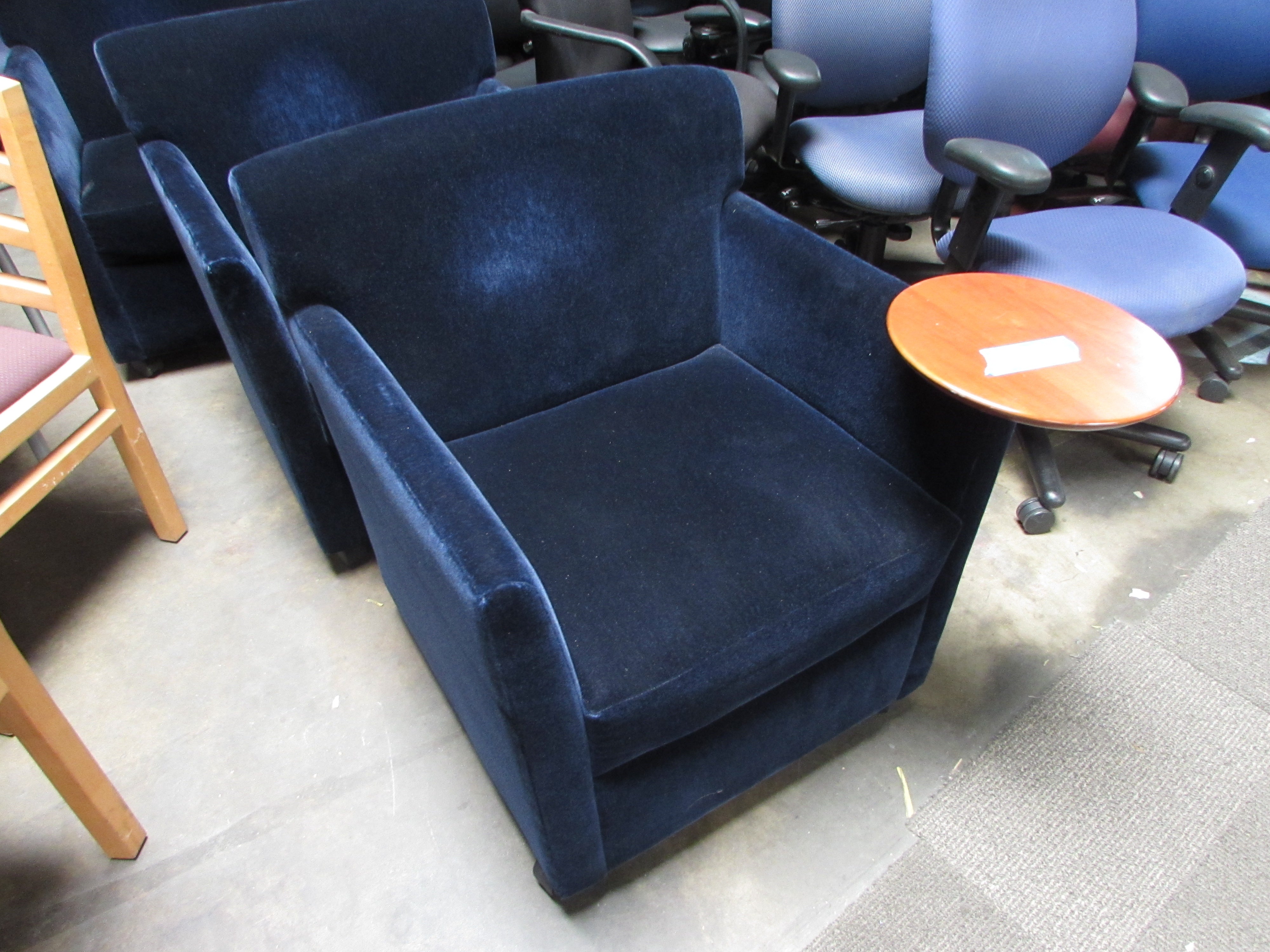 trio of blue felt lobby chairs with trays with wheels