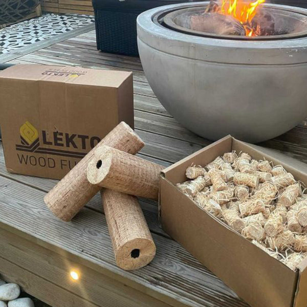 Lekto Wood Fuels Natural Firelighters and Hardwood Heat logs on wooden decking next to a fire pit