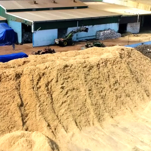 A mountain of sawdust at a briquetting facility.