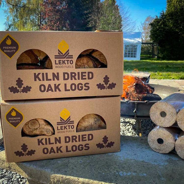 2 boxes of Kiln Dried Oak Logs on a patio