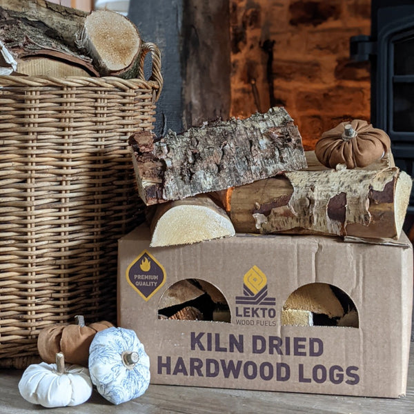 Lekto Wood Fuels Kiln Dried Hard Wood Logs Next to a basket and some garlic