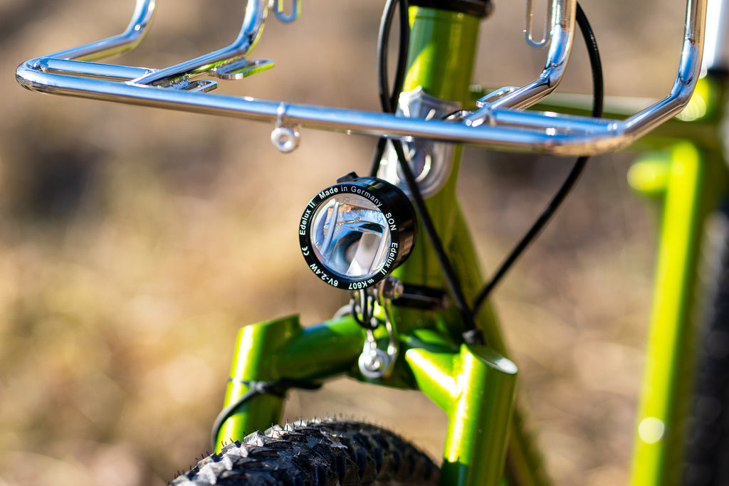 son edelux ii front light on a green velo orange piolet frameset