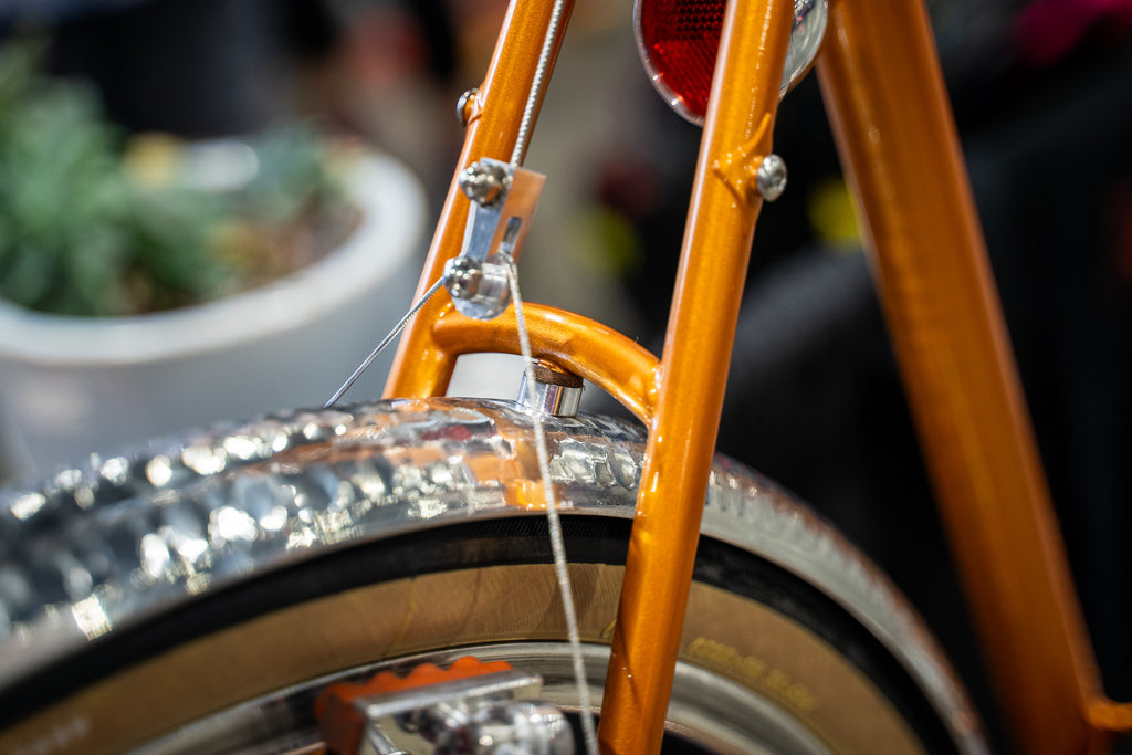 Closeup of a fender mounted to a frame