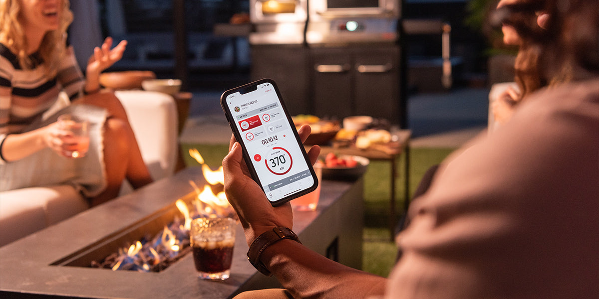 Neevo smart grill being controlled by app on a phone