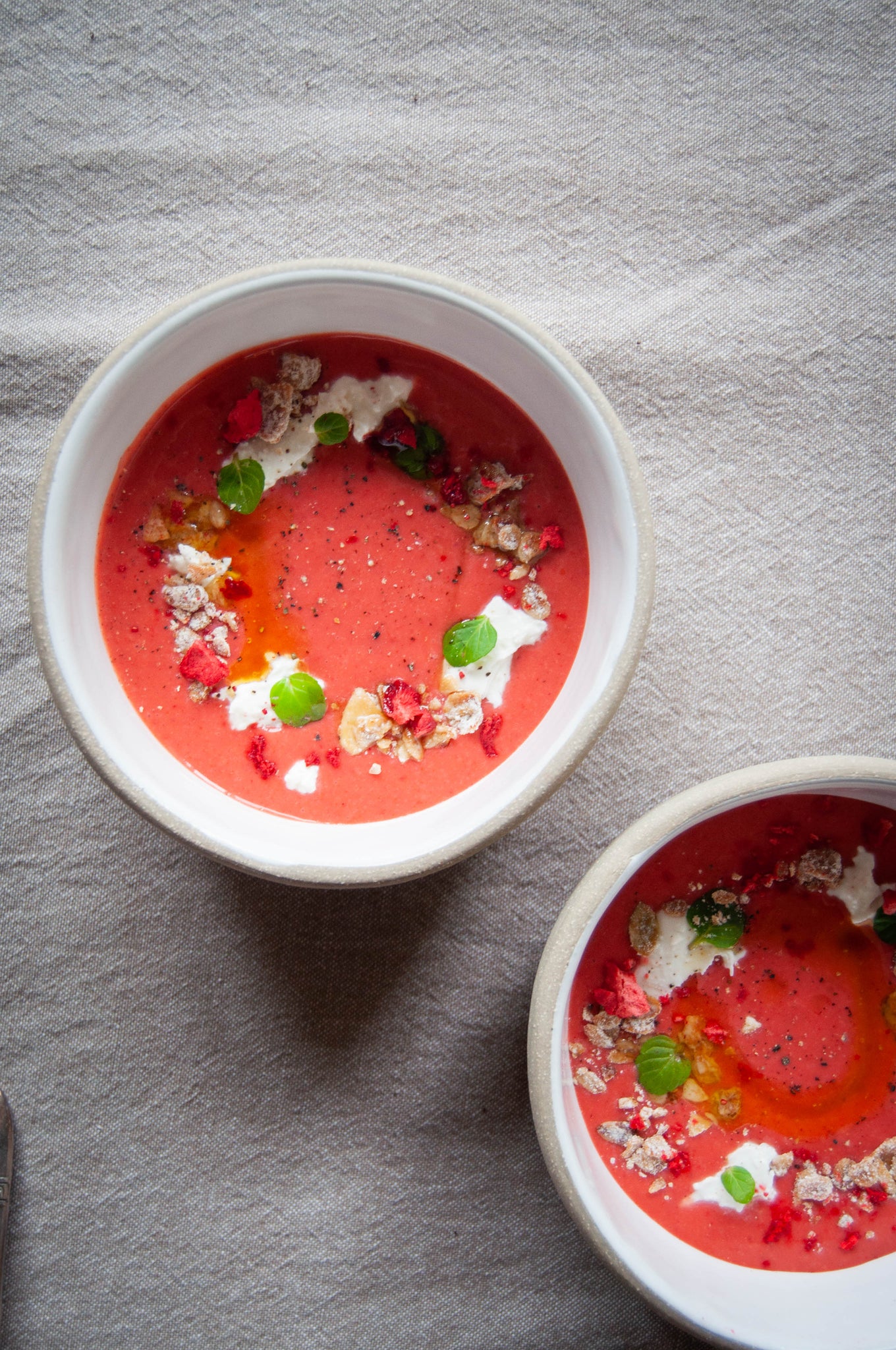 Gazpacho doesn't always need to be made with tomatoes. This one is made from strawberries, then paired with creamy burrata, lemon mint, and sharp cheddar granola from bumble & butter to add a bit of crunch.