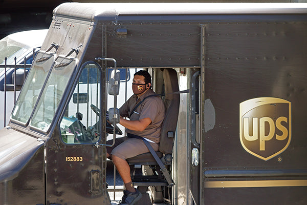 UPS truck and delivery driver in sitting position