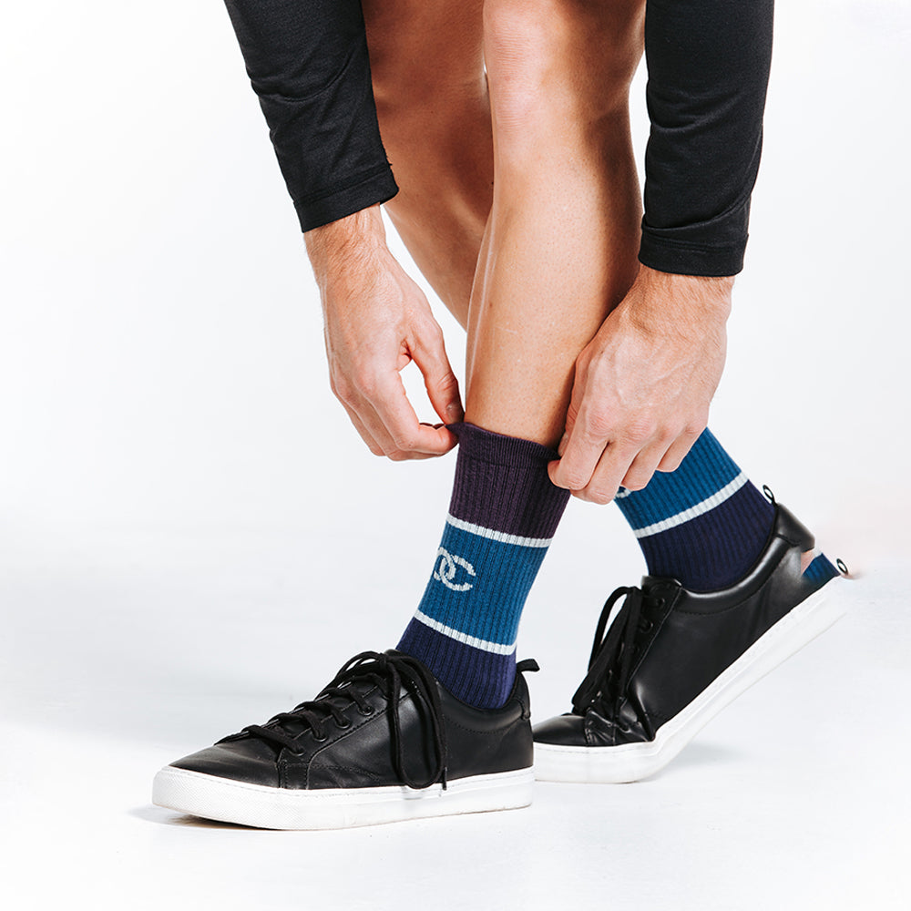 Blue crew length compression socks close up on model