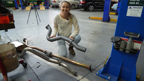 Em holding her Redback Exhaust compared to stock dmax exhaust and muffler