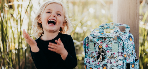 Wolf Gang Designs Backpack, No planet bee design, with boy laughing.