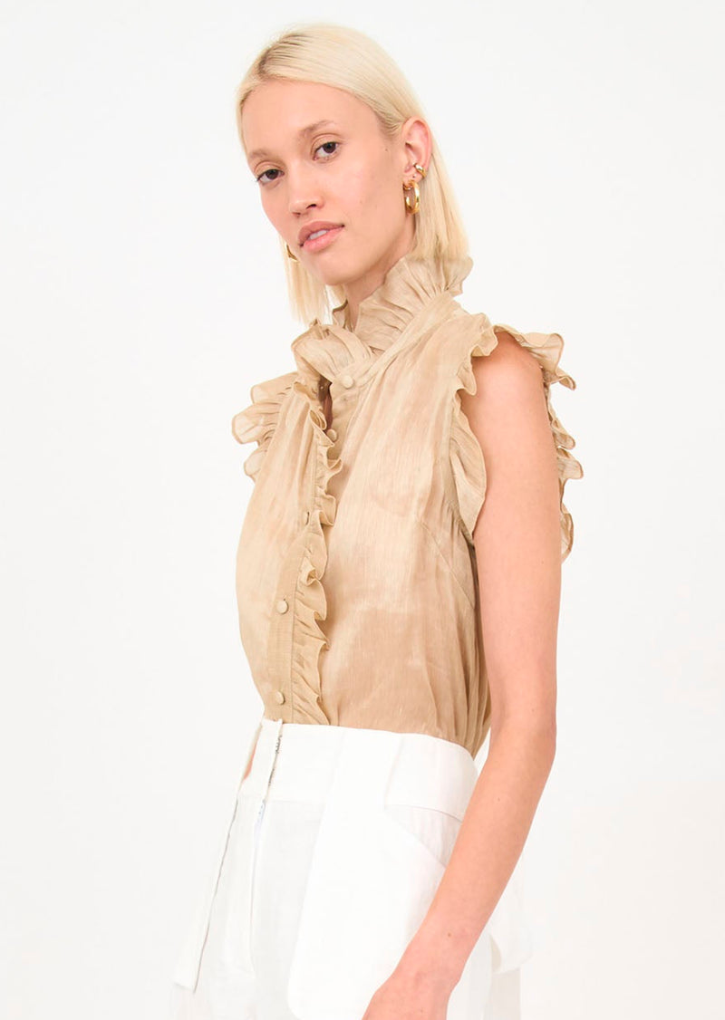 Christy Lynn Marfa Top in Champagne. The Marfa top this season is fashioned in a classic white cotton poplin. It features an asymmetrical side button-down style, a high ruffled neckline, and sleeves. 100% Cotton Poplin Care instructions: hand wash or dry clean Made in NYC The Christy Lynn brand provides luxury ready-to-wear for the modern, yet romantic woman.
