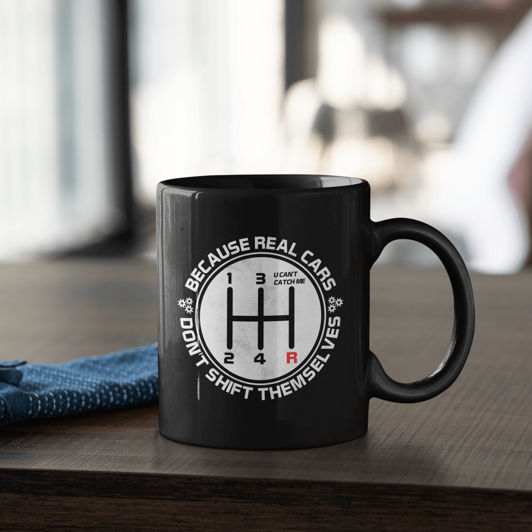 https://cdn.shopify.com/s/files/1/2200/6351/products/real-cars-don_t-shift-themselves-car-mug_1600x.png?v=1644608427