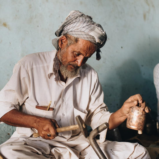 male artisan making bell