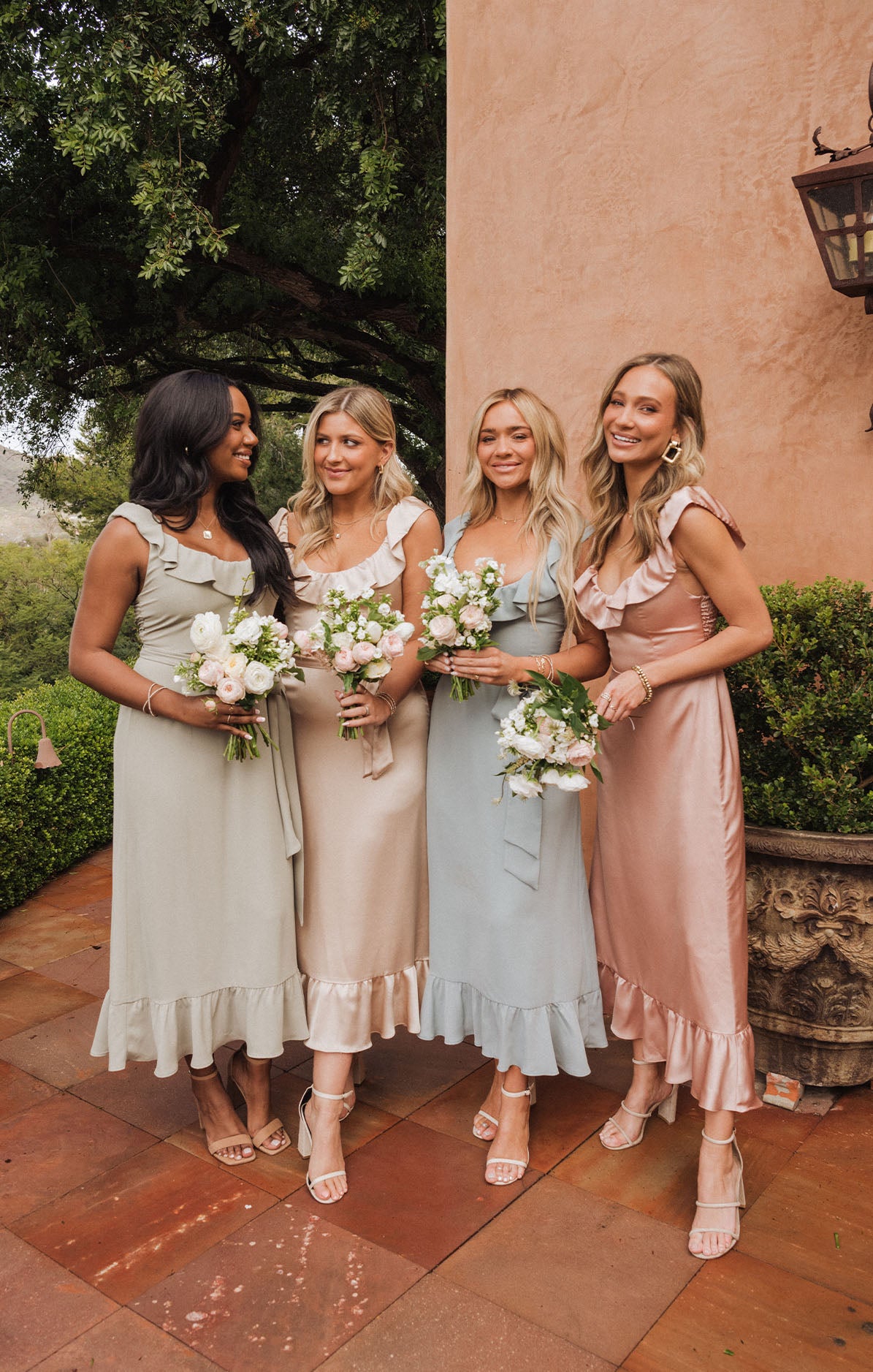 women wearing bridesmaid dresses in different colors