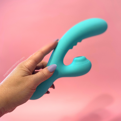 Side view of the Rock Candy Sugarotic dual-stimulation vibrator being held by a hand