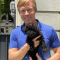 Veterinarian and VAB member Dr. Patrick Mahaney holding a small dog. 