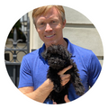 Veterinarian and VAB member Dr. Patrick Mahaney holding a small dog. 