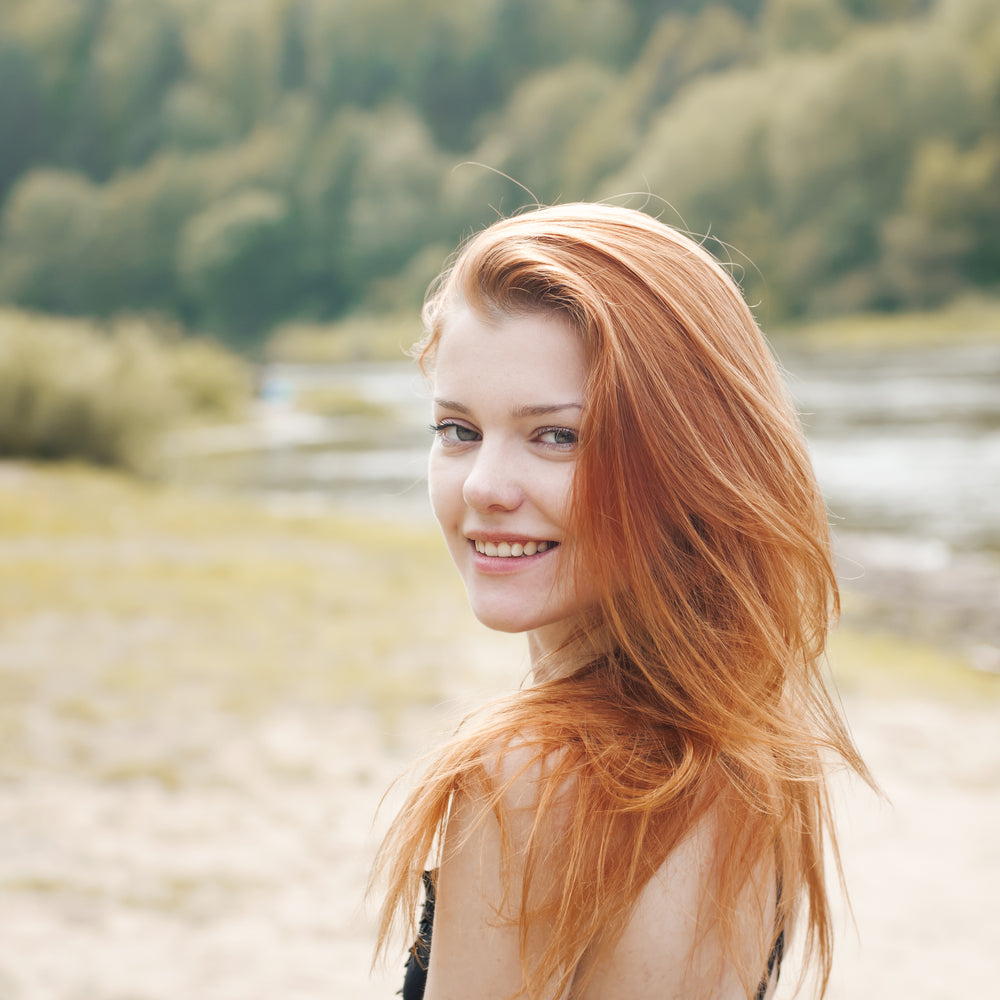 Red head woman smiling at the camera