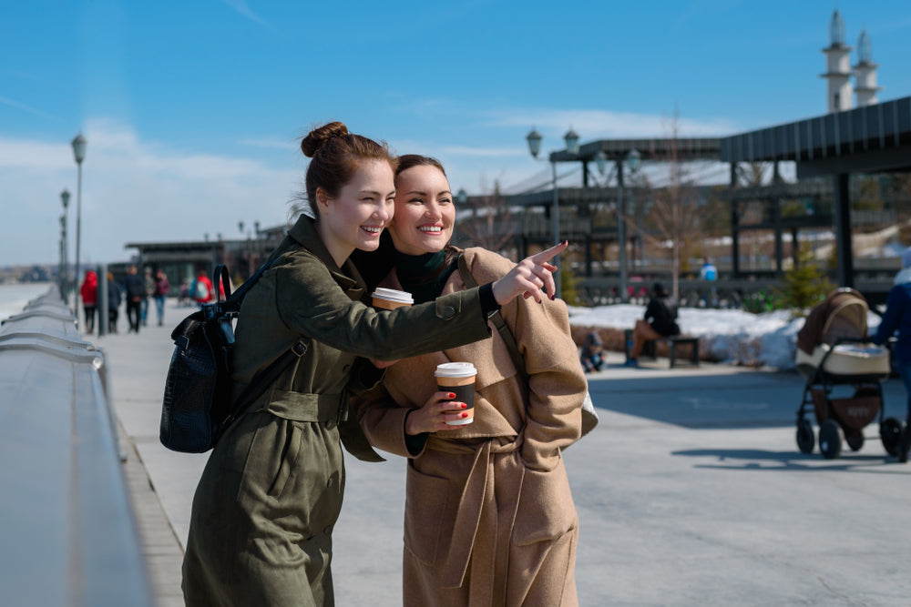 two woman drinking coffee