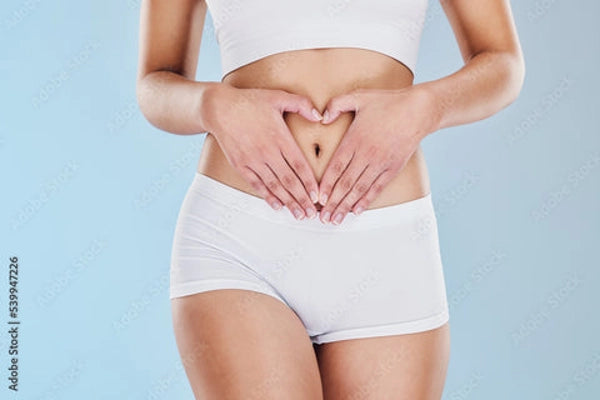 Torso shot of woman in white crop top.