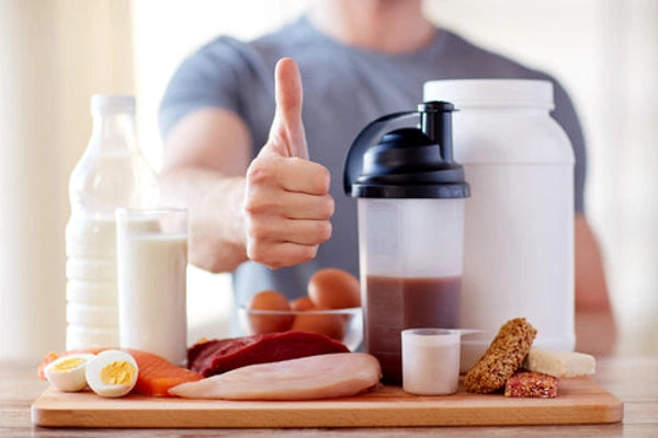 High protein fresh food options, man in background giving a thumbs up