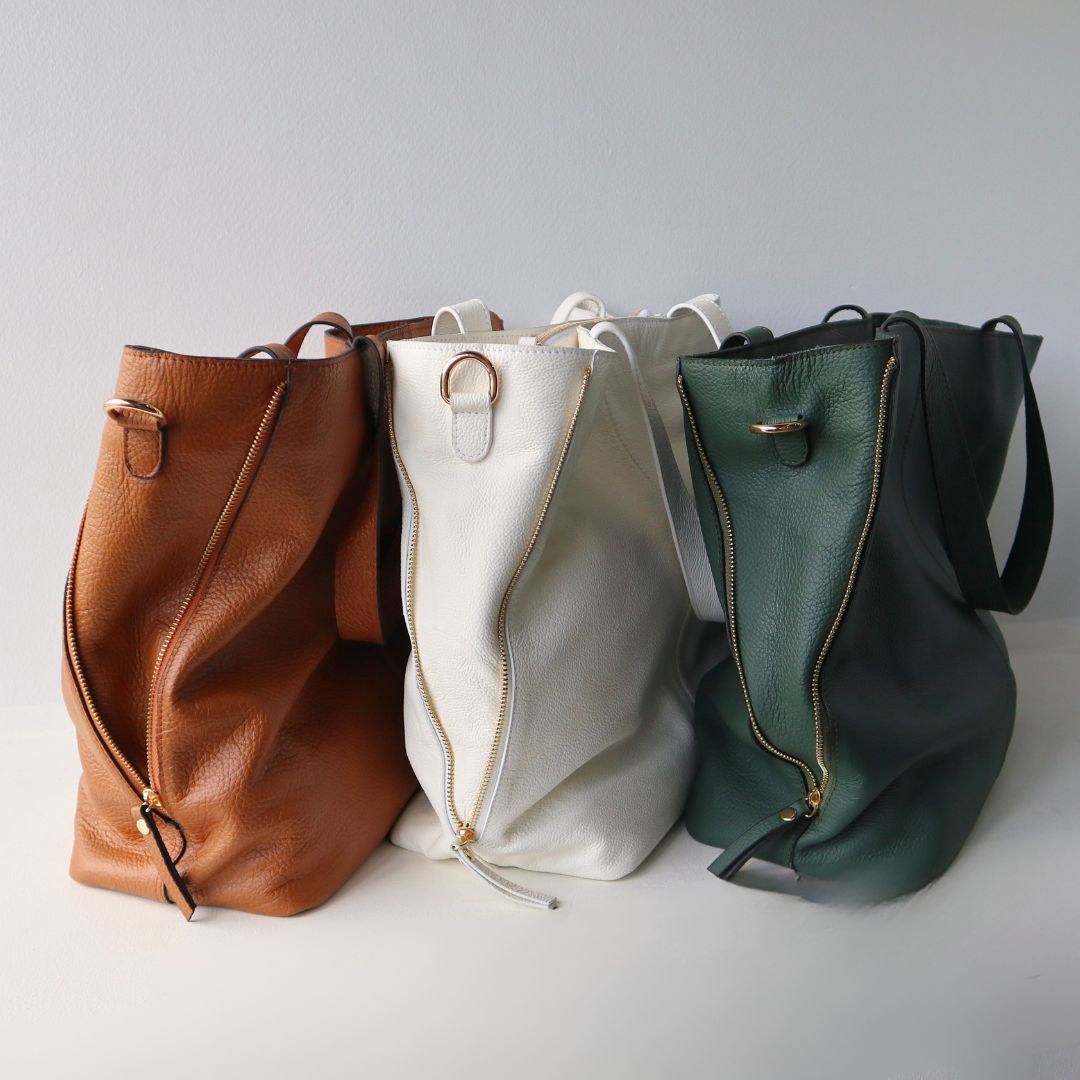 3 leather tote bags in brown white and green