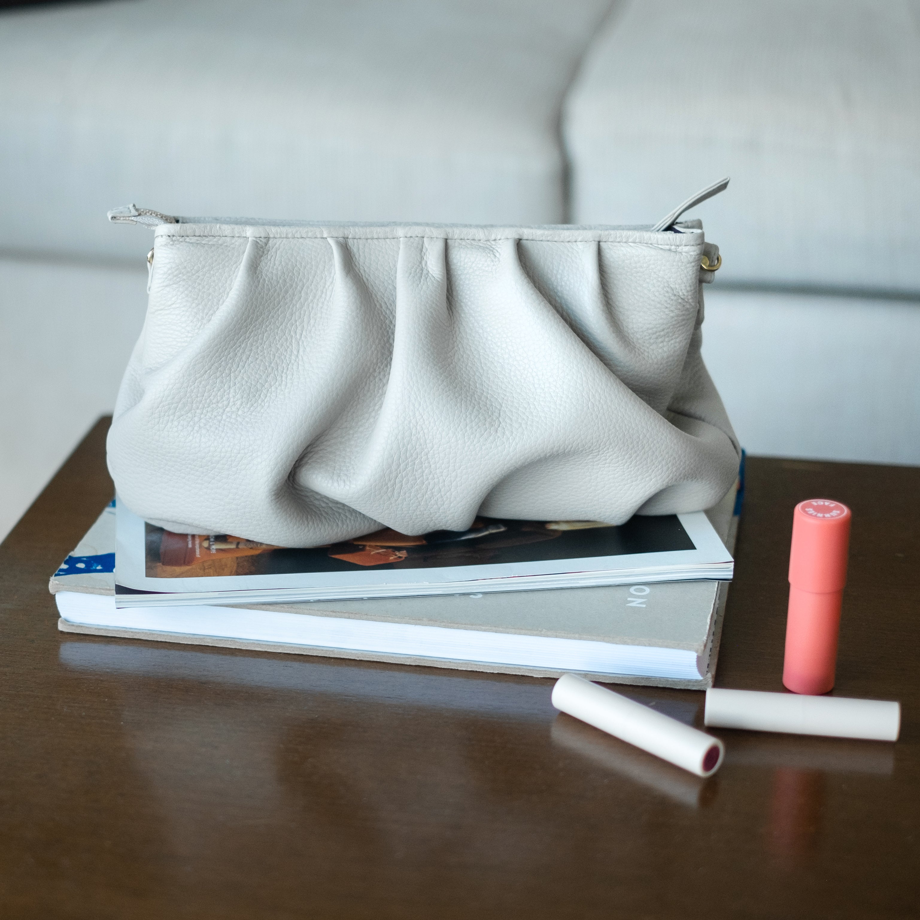 light gray clutch bag on a table