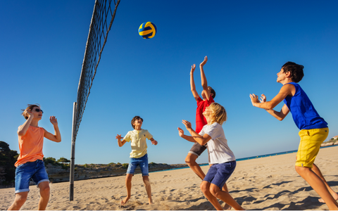 Kids playing beach volleyball