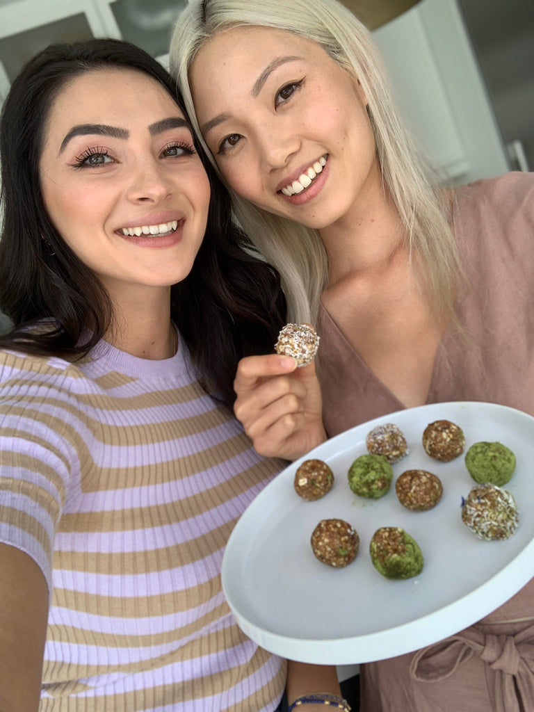 Two women holding a plate of food
