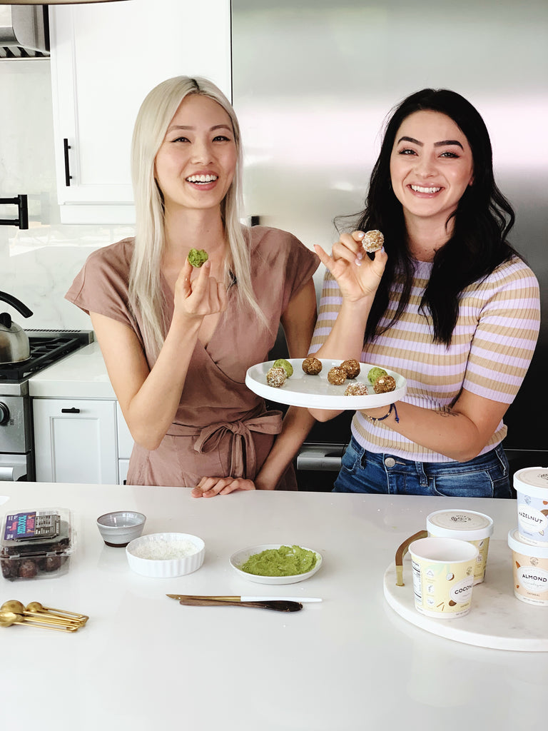 Two women holding plates of food