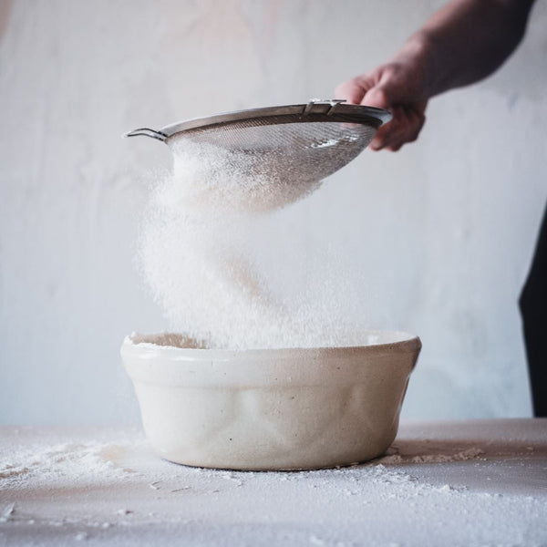 sugar being poured in bowl