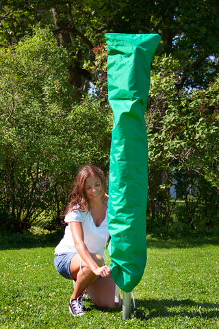 Woman putting a Cover over a Sunshine Clothesline outdoors. 