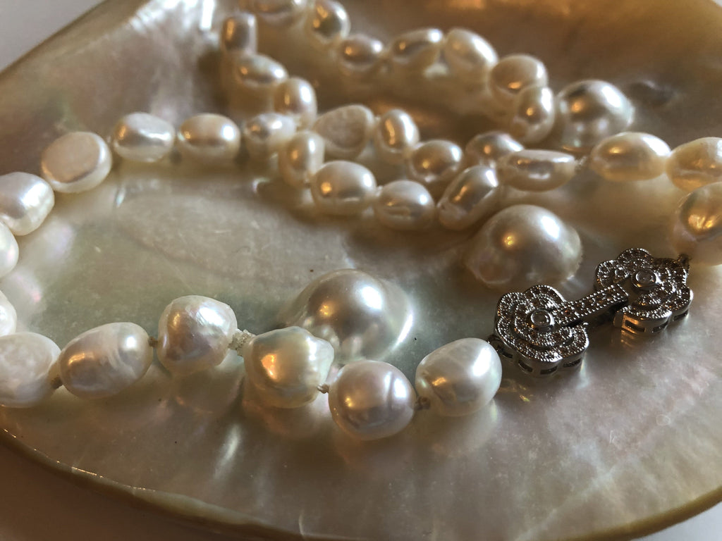 Necklace: Large baroque ivory pearl necklace with a silvertone flower ...