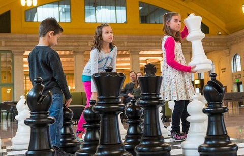 Kids playing with the MegaChess 25 Inch Plastic Giant Chess Set