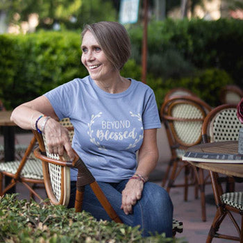 Woman sitting outside wearing a modest Christian shirt