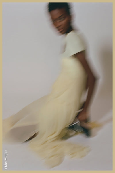 Blurry image of model wearing Sies Marjan dress in yellow. Shot by Theo Wenner.