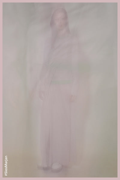 Blurry image of model wearing Sies Marjan Vicki Twist Dress in Mauve color. Shot by Theo Wenner.
