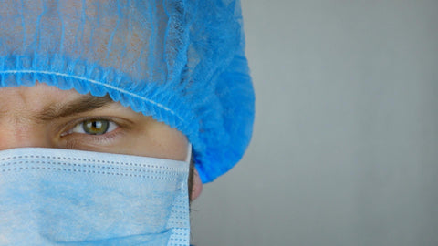 Scientist eyes with his face mask on and hair net